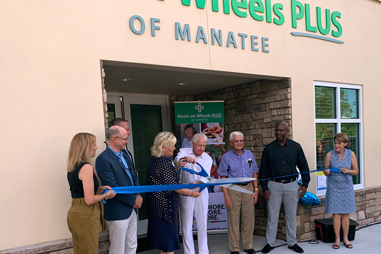MEALS ON WHEELS PLUS OF MANATEE CUTS RIBBON ON NEW BUILDING AND NEW FOOD BANK TRUCK
